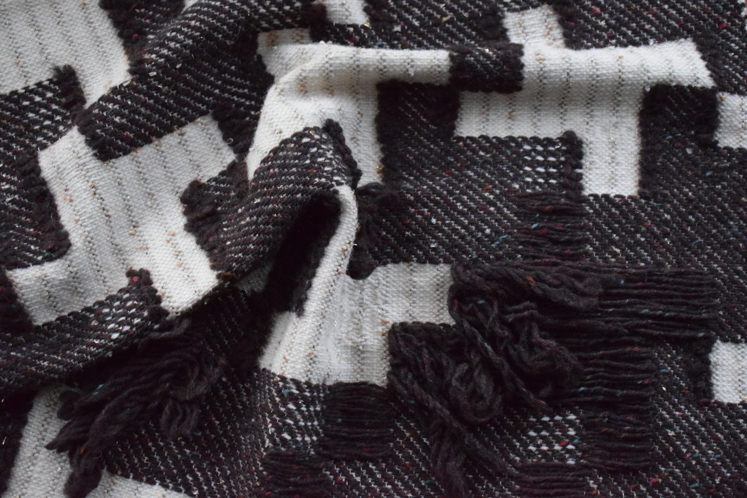 Black and white patterned, woven cloth.